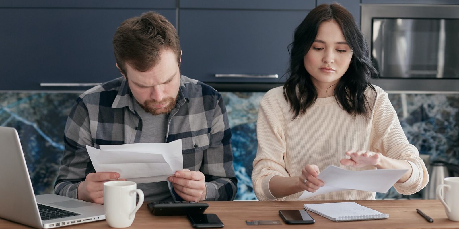 man and woman looking at their financial statements